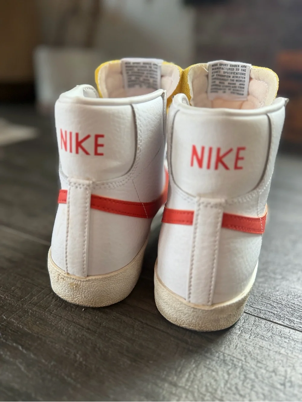 Nike Woman’s White High-Top Sneakers with Red Swoosh